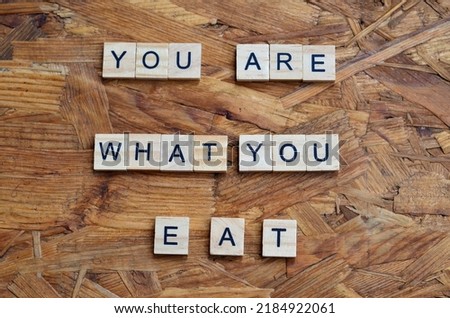 you are what you eat text on wooden square, health and business quotes
