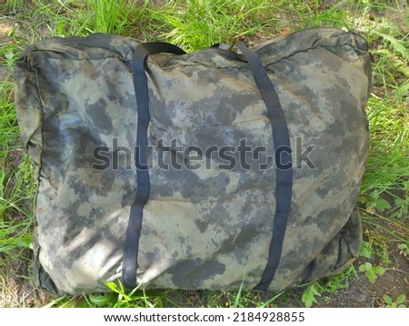 camouflage bag,  tactical bag on the grass