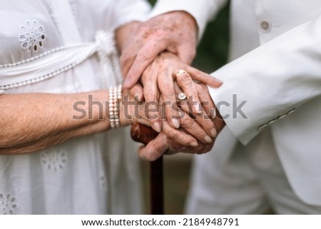 Close-up of seniors hands with wedding rings during their marriage. Royalty-Free Stock Photo #2184948791