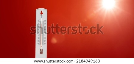 Thermometer with hot Celsius degrees against red background Royalty-Free Stock Photo #2184949163