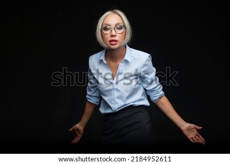 Angry businesswoman in glasses on black background