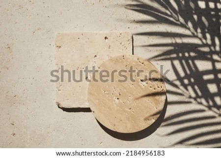 Travertine stone display flat lay podium on travertine stone background and palm shadow. Product promotion Beauty cosmetic showcase. Royalty-Free Stock Photo #2184956183