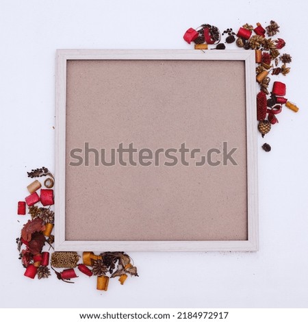 Autumn composition. Photo frame mockup with dried leaves flowers on white background. Autumn, fall, halloween concept. Flat lay, top view, copy space, square.
