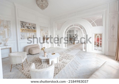 snow-white luxury apartment interior with Egyptian-style decor with light stylish furniture. huge panoramic windows and an archway. minimalism and simplicity with the elegance of modern housing design Royalty-Free Stock Photo #2184983037