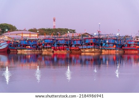 fishing boats leaning in the harbor of Kejawan in Cirebon, West Java, Indonesia Royalty-Free Stock Photo #2184986941
