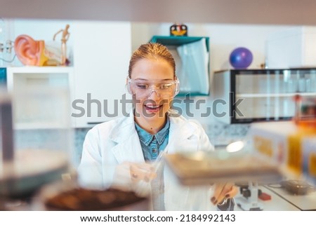 Young Scientist Working in The Laboratory. Female Scientist Working in Nuclear Magnetic Resonance Laboratory, Researching Diseases. This could be the next groundbreaking discovery