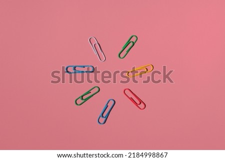 the sun from paper clips on a colored background