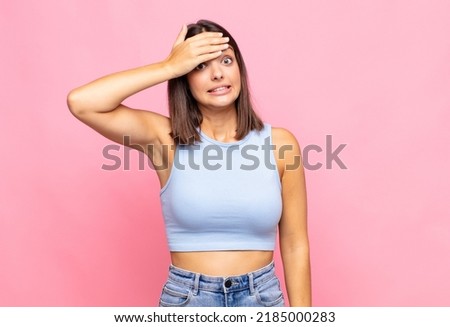 young pretty woman panicking over a forgotten deadline, feeling stressed, having to cover up a mess or mistake Royalty-Free Stock Photo #2185000283