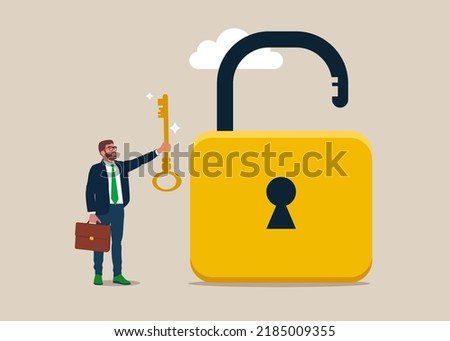 Businessman holding golden key to unlock the pad. Unlock business accessibility. Solve business problem, professional to give solutions. Royalty-Free Stock Photo #2185009355