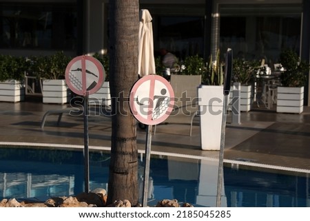 Warning and information signs at the swimming pool in the hotel.