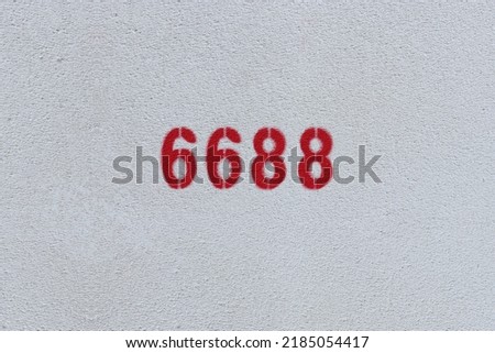 Red Number 6688 on the white wall. Spray paint.
