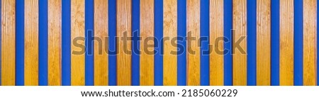 vertical wood lines on a blue wall. Banner for insertion into site.