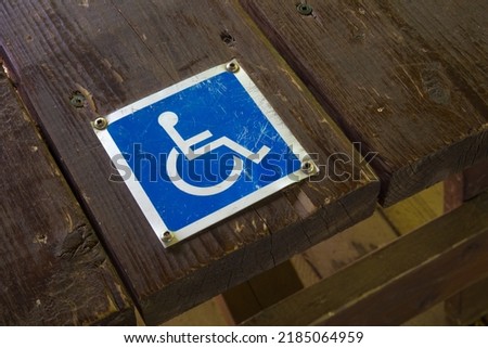 wheelchair handicap sign disabled blue symbol on wood 