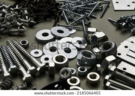 Set of bolts nuts nails metal fasteners. Consumable hardware tools. assortment steel screws collection close up background Royalty-Free Stock Photo #2185066405