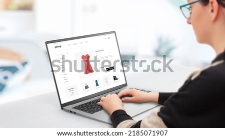 Woman shopping online with laptop. Concept of buying women's clothing online on e-commerce websites  Royalty-Free Stock Photo #2185071907
