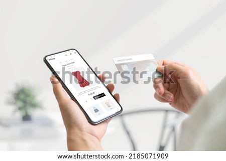 Shopping online with smart phone and credit card concept. Modern e-commerce web page with with women's clothing Royalty-Free Stock Photo #2185071909