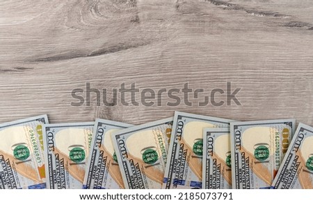 Dollars are beautifully laid out on a uniform background. You can see some of the banknotes.