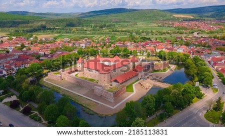Aerial photography of the Citadel of Fagaras, in Brasov county, Romania. Photography was shot from a drone with camera tilted downwards at a lower angle. Birds eye view over medieval fort 