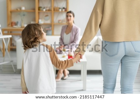 Concept of a happy healthy relationship between children and parents. Go to a family psychologist. Mom holds the hand of her not quite year old son. Royalty-Free Stock Photo #2185117447