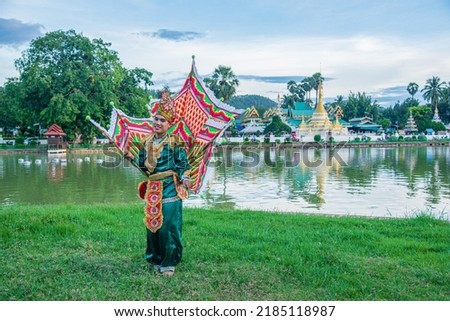 Dressing like a bird, wearing wings, posing for music, dancing, performing Burmese arts