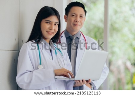 Asian two male female professional doctor using computer laptop checking patient's medical records ,Portrait doctor healthcare professionals