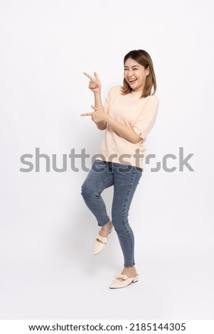 Young beautiful Asian woman pointing to empty copy space isolated on white background, Full body composition Royalty-Free Stock Photo #2185144305