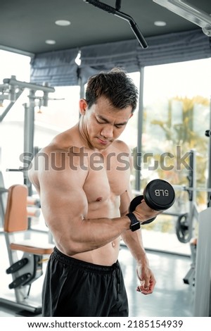 Asian men exercise by lifting weights or lifting dumbbells. Asian bodybuilder fitness concept