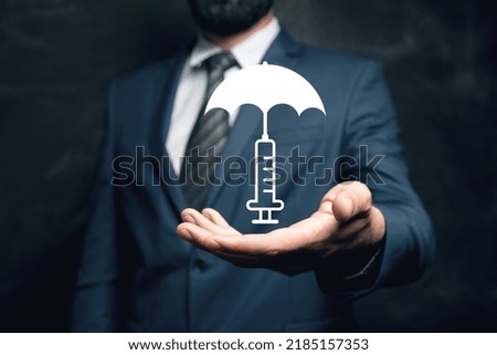 Icon of a syringe with an umbrella. Vaccination concept. Man holding in his hand