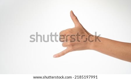 woman's hand gesture greeting surfers shaka thumb and little finger protruded Royalty-Free Stock Photo #2185197991