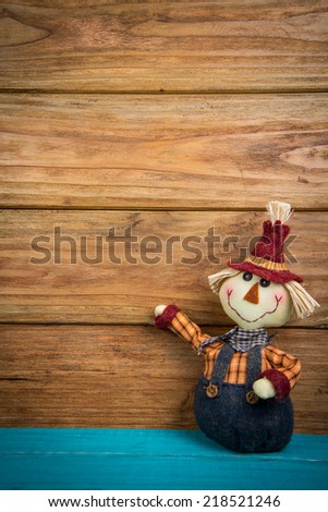 Halloween funny  scarecrow on wooden background