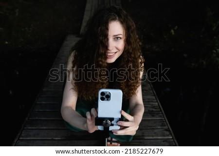Woman taking photos with a mobile phone