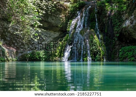 Waterfall in The Valley of Butterflies. The Petaloudes valley nature reserve in Rhodes, Greece, Europe. Royalty-Free Stock Photo #2185227751
