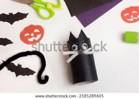 Step by step photo instruction Halloween craft. Step 9 Handmade decoration cute funny cat from toilet paper roll. Do it yourself. Reuse concept