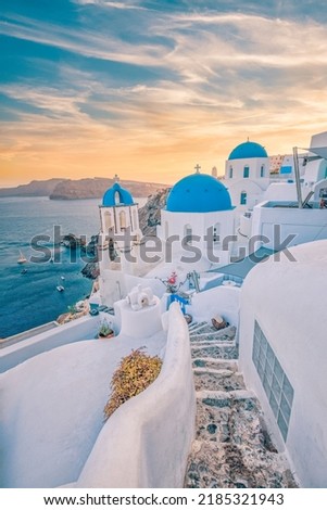 Fantastic Mediterranean Santorini island, Greece. Amazing romantic sunrise in Oia background, morning light. Amazing sunset view with white houses blue domes. Panoramic travel landscape. Lovers island Royalty-Free Stock Photo #2185321943