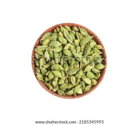 Wooden bowl with dry cardamom seeds isolated on white, top view Royalty-Free Stock Photo #2185345993