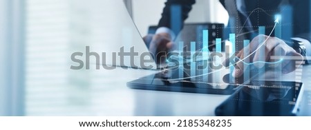 Business analysis. Businessman working on laptop computer analyzing finance sales data and economic growth graph chart and financial report, business and technology concept. Royalty-Free Stock Photo #2185348235