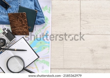 Accessories for travelling with passports on white wooden background
