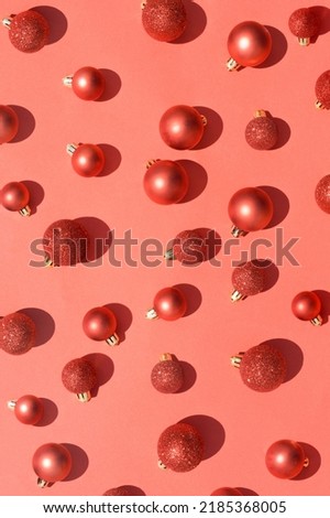 Christmas ornament background in vibrant bold red color. Monochrome red bauble wallpaper.