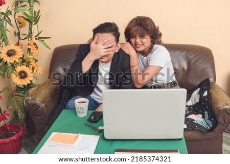 A young man and woman watching movies. A couple relaxing after a tiring work. Enjoying both of their free time.