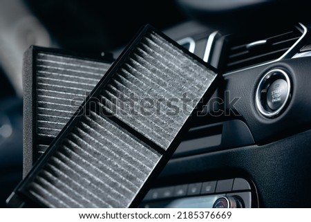 New air conditioner cabin air filter with activated carbon. Royalty-Free Stock Photo #2185376669