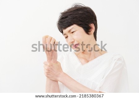 Asian senior woman having the joint pain in white background