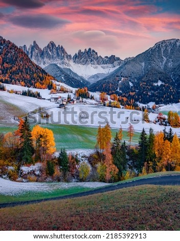 First snow fallen on green hills on Santa Magdalena village with Seceda peak. Picturesque autumn scene of Dolomites, Italy. Calm morning view of popular tourist destination - Santa Maddalena church. Royalty-Free Stock Photo #2185392913
