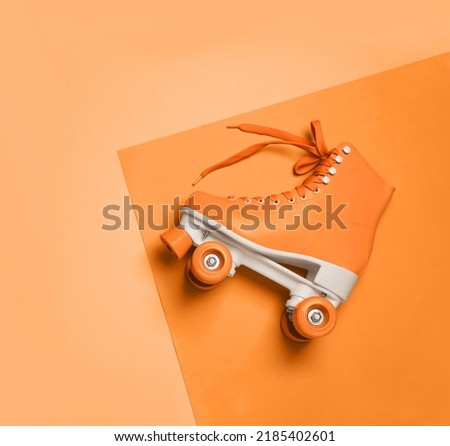 Stylish quad roller skate on orange background, top view Royalty-Free Stock Photo #2185402601