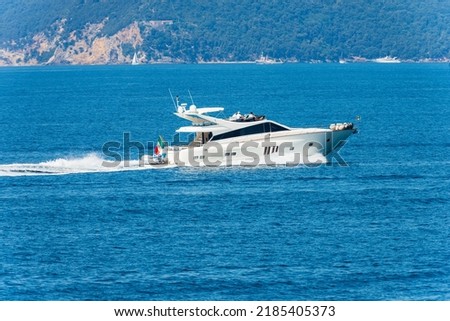 White luxury yacht or speedboat in motion on Mediterranean sea in front of the Palmaria island, Porto Venere or Portovenere, Gulf of La Spezia, La Spezia, Liguria, Italy, Europe. Royalty-Free Stock Photo #2185405373
