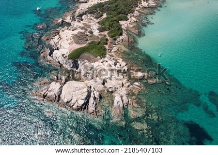 Natural sea environment. Bird's eye perspective of coastal rock formation of Karydi beach and surrounding see-through turquoise sea water. Greece. High quality photo