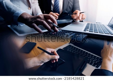 Businessman and team analyzing financial statement Finance task. with smart phone and laptop and tablet. Wealth management concept