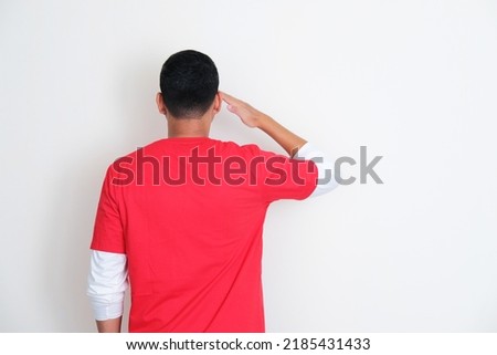 Back view on Indonesian man give salute during independence day celebration Royalty-Free Stock Photo #2185431433