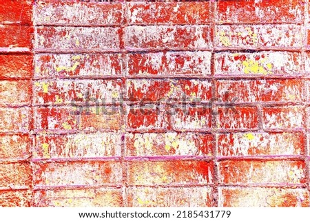 Peeling paint on a brick wall. Old brick wall with cracked peeling paint. Weathered rough painted surface with patterns of cracks and peeling. Changed color scheme. Colorful background