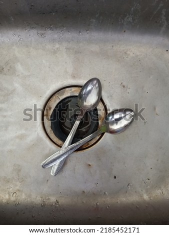 two spoons in the sink pictured from above
