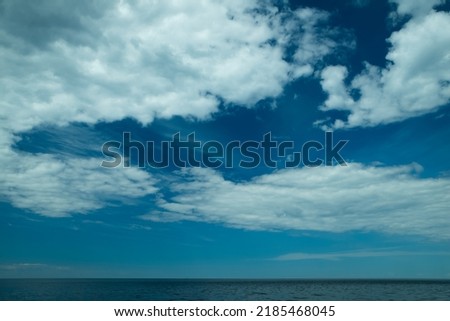 Scenic seascape of calm sea and blue sky with clouds. Beautiful landscape.